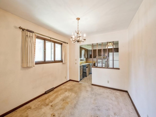 unfurnished dining area with a chandelier, baseboards, and light colored carpet