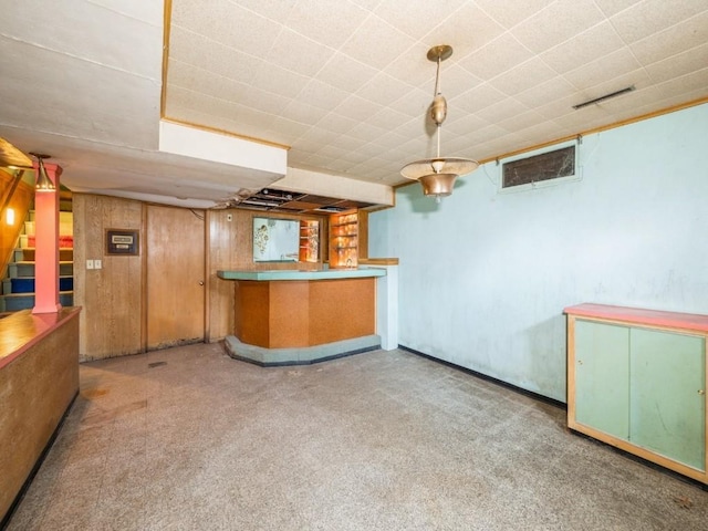indoor bar with stairway and carpet flooring