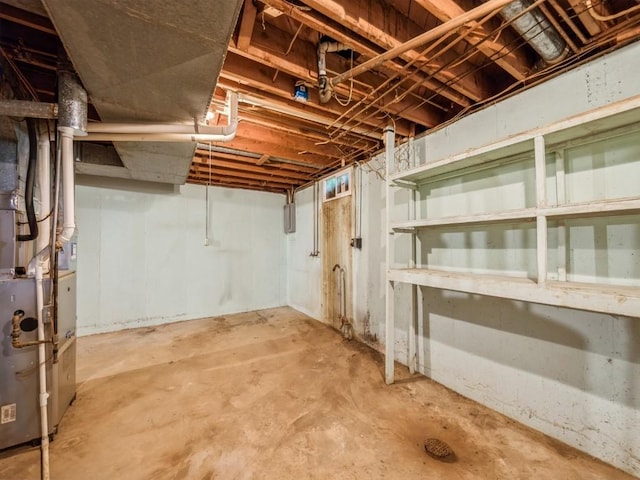 unfinished below grade area featuring heating unit