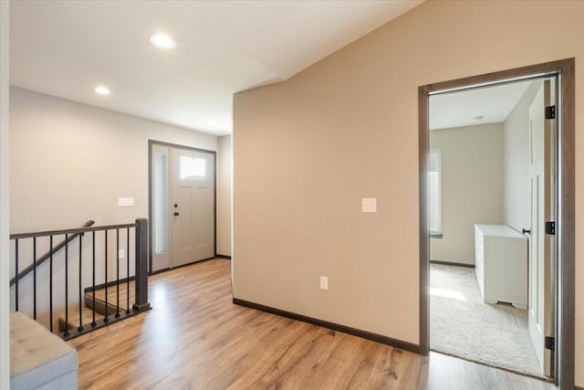 412 Dawson Dr, West Branch, IA 52358 - hall with light wood finished floors, an upstairs landing, baseboards, and recessed lighting