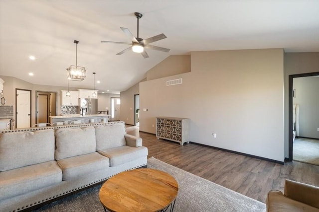412 Dawson Dr, West Branch, IA 52358 - living room featuring ceiling fan, wood finished floors, lofted ceiling, baseboards, and recessed lighting