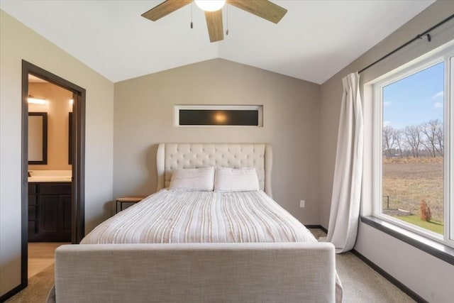 412 Dawson Dr, West Branch, IA 52358 - bedroom with carpet floors, vaulted ceiling, connected bathroom, and ceiling fan