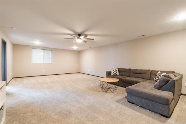 412 Dawson Dr, West Branch, IA 52358 - living area featuring light carpet, baseboards, and a ceiling fan