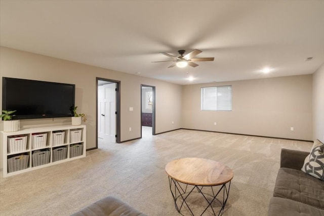 412 Dawson Dr, West Branch, IA 52358 - living area with light carpet, a ceiling fan, and baseboards