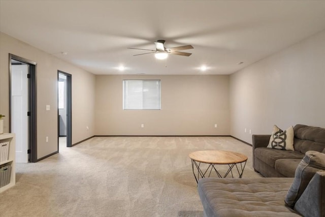 412 Dawson Dr, West Branch, IA 52358 - living area featuring light carpet, ceiling fan, and baseboards
