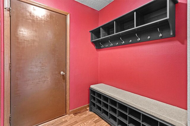 206 Hilltop Rd SW, Swisher, IA 52338 - mudroom featuring wood finished floors and a textured ceiling