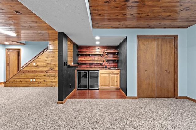 206 Hilltop Rd SW, Swisher, IA 52338 - indoor dry bar featuring carpet flooring, wine cooler, wooden ceiling, baseboards, and wood walls