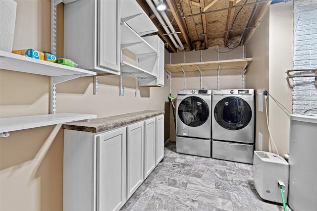 206 Hilltop Rd SW, Swisher, IA 52338 - laundry area featuring independent washer and dryer and cabinet space
