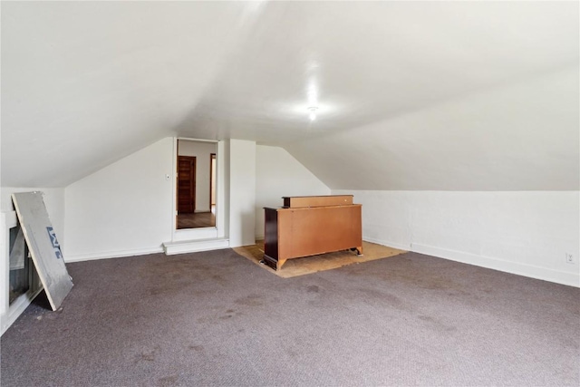 829 Union Ave, Lowden, IA 52255 - additional living space with vaulted ceiling, carpet floors, and baseboards