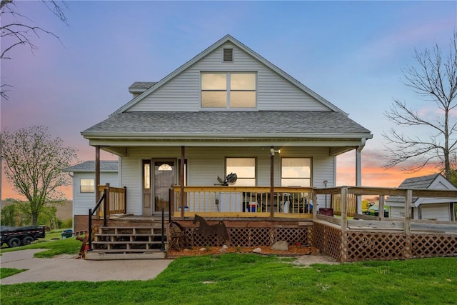829 Union Ave, Lowden, IA 52255 - back of house with a shingled roof, a lawn, and a porch