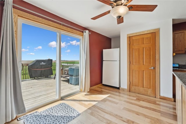829 Union Ave, Lowden, IA 52255 - doorway featuring light wood-style floors, ceiling fan, and baseboards