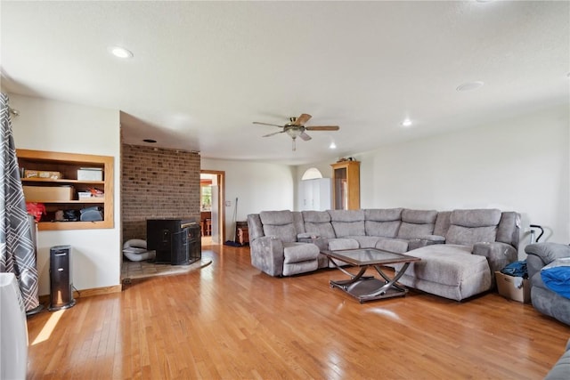 829 Union Ave, Lowden, IA 52255 - living area featuring a wood stove, hardwood / wood-style flooring, ceiling fan, recessed lighting, and arched walkways