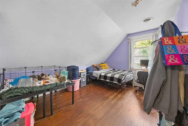 bedroom featuring hardwood / wood-style floors and vaulted ceiling