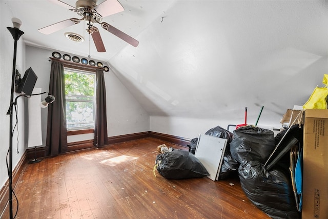 additional living space featuring hardwood / wood-style flooring, vaulted ceiling, a ceiling fan, and baseboards