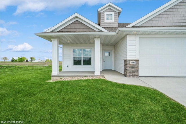 2559 Bluegrass St, Marion, IA 52302 - view of front of house featuring covered porch, a front yard, and an attached garage