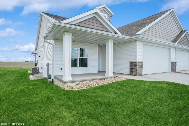 2559 Bluegrass St, Marion, IA 52302 - view of front of house featuring covered porch, an attached garage, driveway, a front yard, and roof with shingles