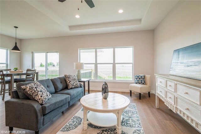 2559 Bluegrass St, Marion, IA 52302 - living area with light wood-style floors, ceiling fan, recessed lighting, a tray ceiling, and baseboards
