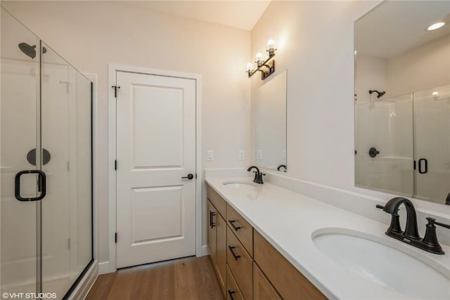 2559 Bluegrass St, Marion, IA 52302 - bathroom featuring a stall shower, wood finished floors, and double vanity
