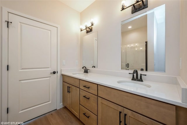 2559 Bluegrass St, Marion, IA 52302 - bathroom featuring a shower stall, wood finished floors, and double vanity