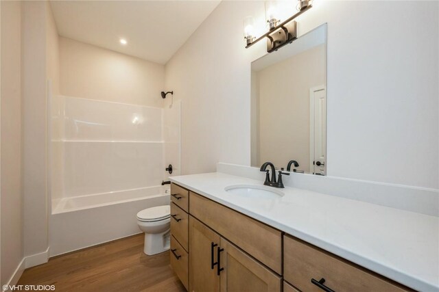 2559 Bluegrass St, Marion, IA 52302 - full bathroom with wood finished floors, toilet, vanity, and bathing tub / shower combination