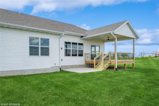 2559 Bluegrass St, Marion, IA 52302 - rear view of house with a shingled roof, a wooden deck, a yard, ceiling fan, and a patio area