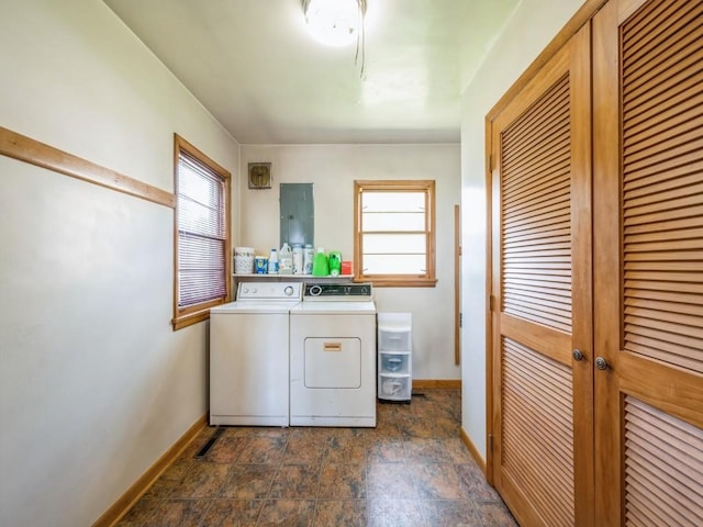404 3rd St, Keystone, IA 52249 - laundry room featuring washing machine and dryer, baseboards, and stone finish flooring
