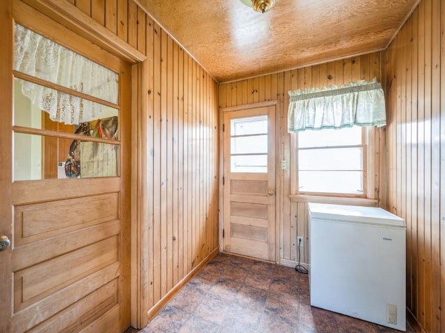 404 3rd St, Keystone, IA 52249 - doorway to outside featuring wooden walls and stone finish floors