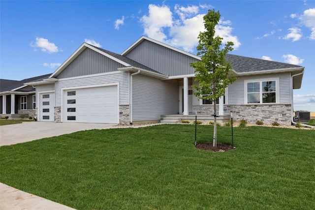 1356 Hickory Ridge Dr, Marion, IA 52302 - view of front of home with an attached garage, stone siding, a front lawn, concrete driveway, and covered porch