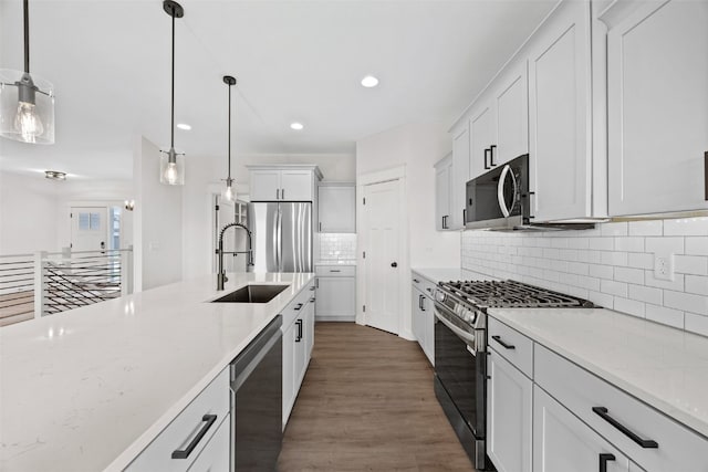 1356 Hickory Ridge Dr, Marion, IA 52302 - kitchen with appliances with stainless steel finishes, a sink, recessed lighting, decorative light fixtures, and decorative backsplash