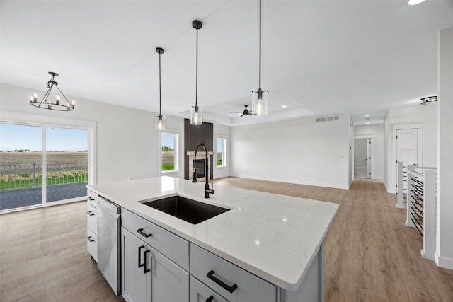 1356 Hickory Ridge Dr, Marion, IA 52302 - kitchen with a sink, dishwasher, light wood-style floors, and decorative light fixtures