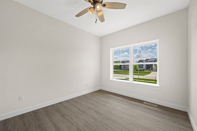 1356 Hickory Ridge Dr, Marion, IA 52302 - unfurnished room with baseboards, wood finished floors, and a ceiling fan