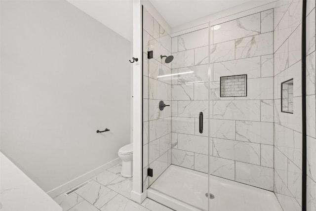 1356 Hickory Ridge Dr, Marion, IA 52302 - bathroom featuring marble finish flooring, a shower stall, baseboards, and toilet