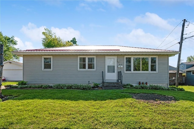 single story home featuring a front yard, metal roof, and entry steps