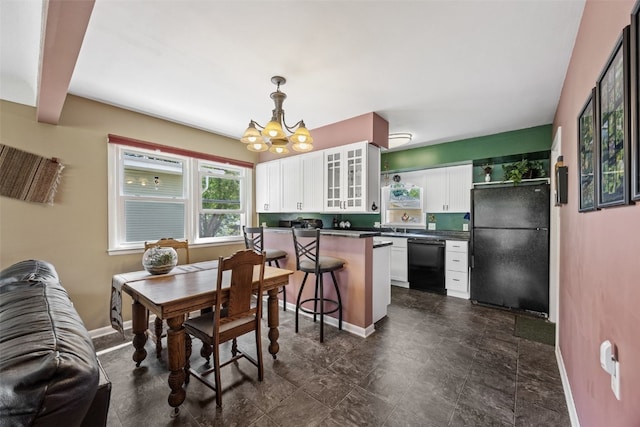 dining room with a chandelier and baseboards