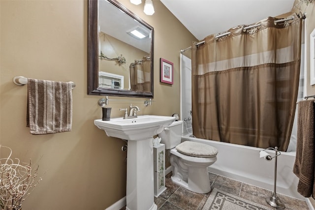 bathroom with shower / bath combo, toilet, and baseboards