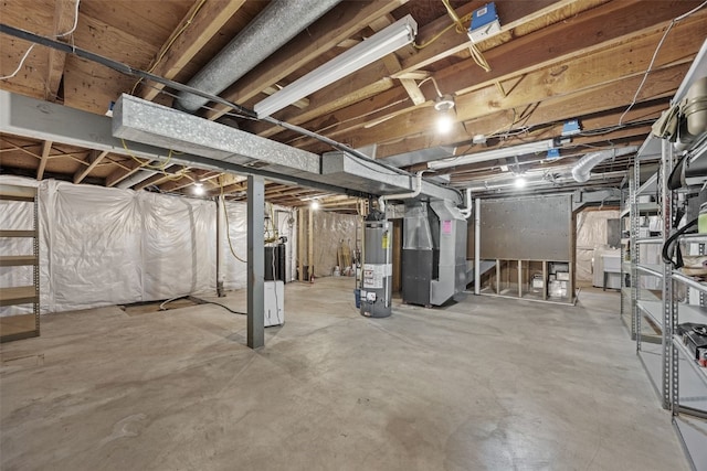unfinished basement featuring water heater, heating unit, and washer / clothes dryer