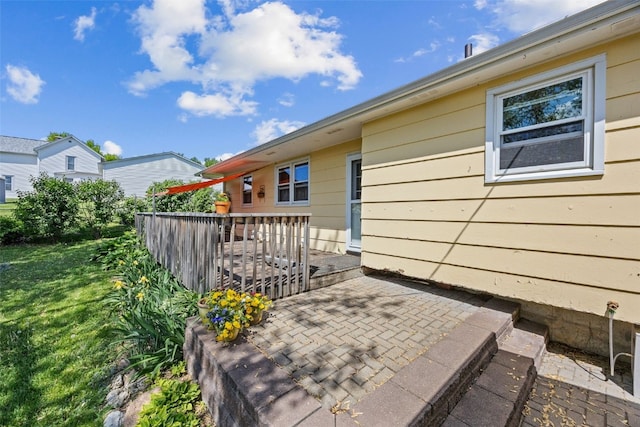 wooden terrace with a patio area and a lawn