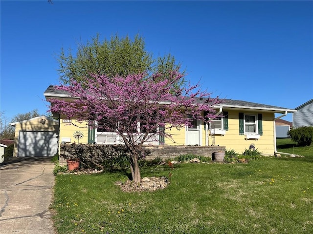 view of front facade with an outdoor structure, a front lawn, concrete driveway, and a detached garage
