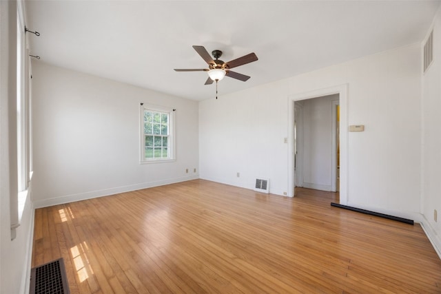 4378 480th St SE, Iowa City, IA 52240 - unfurnished room featuring light wood-style floors, a ceiling fan, and baseboards