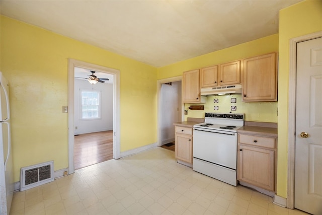 4378 480th St SE, Iowa City, IA 52240 - kitchen featuring white appliances, light brown cabinets, under cabinet range hood, light floors, and ceiling fan