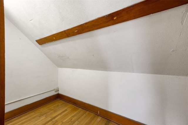 4378 480th St SE, Iowa City, IA 52240 - additional living space with lofted ceiling, light wood finished floors, and baseboards