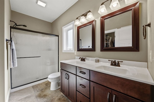full bath with a stall shower, double vanity, toilet, and tile patterned flooring