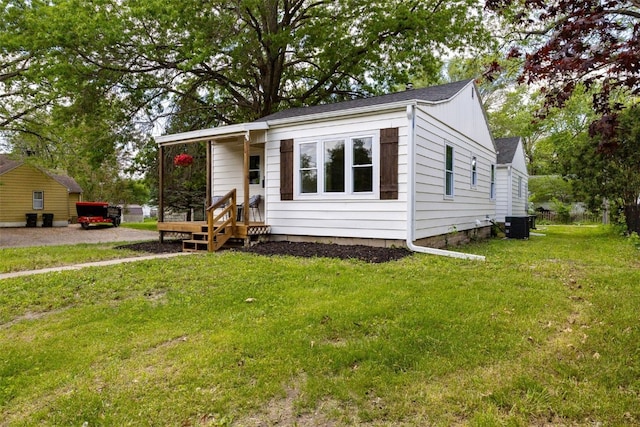 841 S 7th St, Iowa City, IA 52240 - view of front of property featuring a front yard, central AC, and board and batten siding