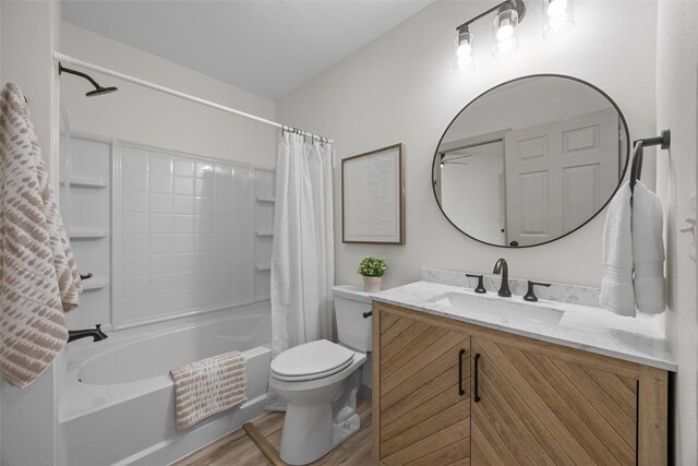 841 S 7th St, Iowa City, IA 52240 - bathroom featuring toilet, wood finished floors, shower / tub combo, and vanity