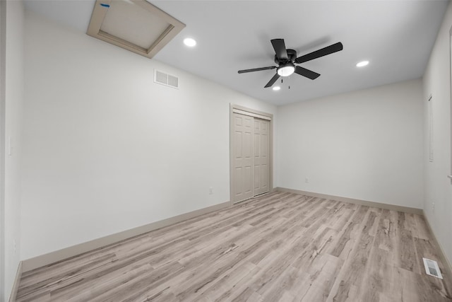 841 S 7th St, Iowa City, IA 52240 - unfurnished bedroom featuring attic access, light wood-style floors, a closet, recessed lighting, and baseboards