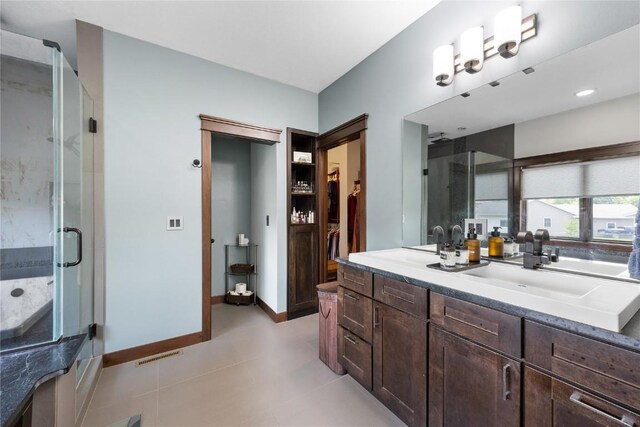 302 6th St NE, Mount Vernon, IA 52314 - full bath with a shower stall, vanity, and baseboards