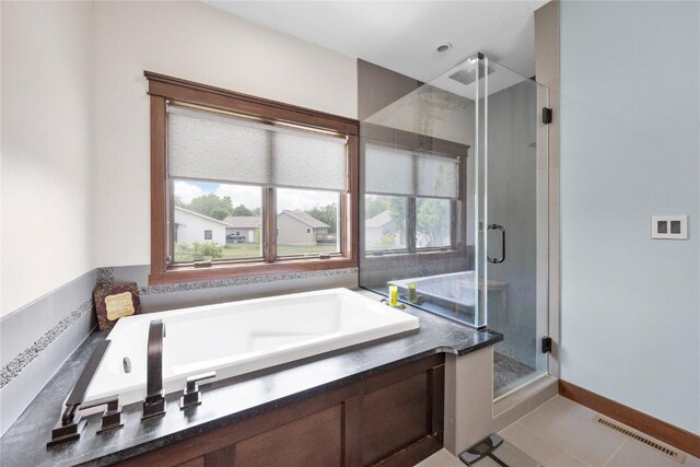 302 6th St NE, Mount Vernon, IA 52314 - bathroom with a shower stall, a garden tub, and tile patterned flooring