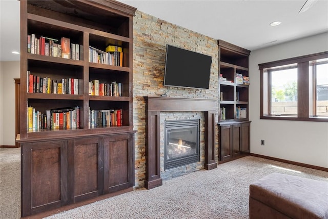 302 6th St NE, Mount Vernon, IA 52314 - living area with carpet flooring, a fireplace, baseboards, built in features, and recessed lighting