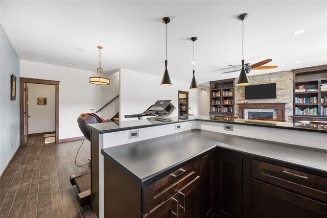 302 6th St NE, Mount Vernon, IA 52314 - kitchen featuring dark countertops, a ceiling fan, a fireplace, dark wood finished floors, and recessed lighting
