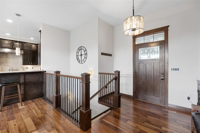 302 6th St NE, Mount Vernon, IA 52314 - entryway featuring dark wood finished floors, baseboards, a chandelier, and recessed lighting